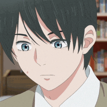 a close up of a boy with blue eyes