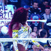 a woman in a boxing ring with a caution tape around her arms