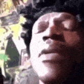 a close up of a person 's face with their eyes closed and a blurred background .