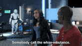 a man and a woman are standing in a room with the woman saying somebody call the whaa-mbulance