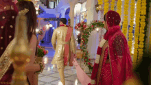 a bride and groom are walking through a room decorated with yellow flowers