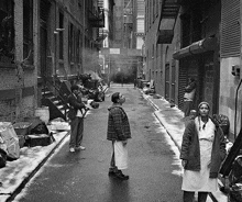 a black and white photo of a narrow alleyway