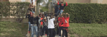 a group of young men are posing for a picture with one wearing a red shirt that says ' chicago '