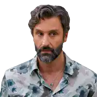 a man with a beard wears a floral shirt