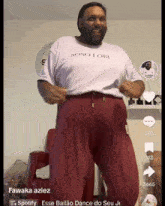 a man wearing a white shirt that says soso lobi is dancing