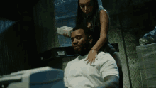 a woman is sitting on a man 's back holding money