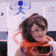 a woman wearing a ponytail and a hoop around her neck