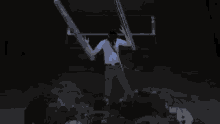 a man in a white shirt is holding a sword in his hands
