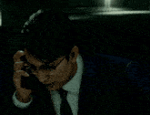 a man wearing glasses and a suit is talking on a cell phone
