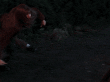 a man and a woman are fighting over a red and white barricade