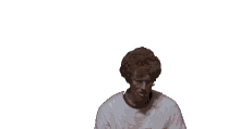 a man wearing glasses and a white shirt is sitting in front of a bunch of hands .