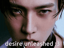 a close up of a man 's face with the words " desire unleashed " written below it
