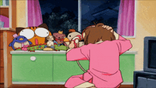 a girl in a pink shirt is talking on a telephone