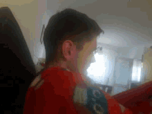 a man wearing a red shirt that says ' ao ' on it