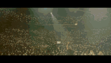 a crowd of people watching a concert with a lot of lights