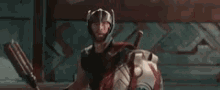 a man in a helmet is standing in front of a wall and says yes .