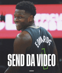 a basketball player with the name edwards on the back of his shirt