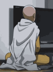 a man is sitting in front of a sharp tv