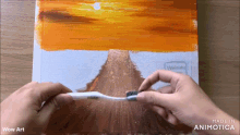 a person is holding a toothbrush in front of a painting that says wow art on it