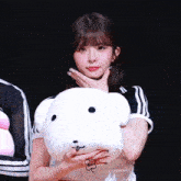 a girl is holding a stuffed animal that says lucky