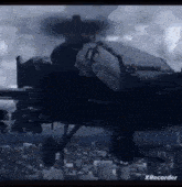 a helicopter is flying over a city with a propeller .