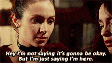 two women are talking and one of them is saying " hey i 'm not saying it 's gonna be okay
