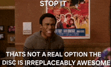 a man is standing in front of a movie poster that says stop it that 's not a real option the disc is irreplaceably awesome