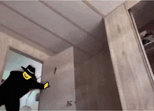 a cartoon drawing of a man in a black hat standing in a room