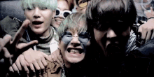 a group of young men are posing for a picture while wearing sunglasses .