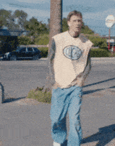 a man wearing a sleeveless shirt that says cliche on it