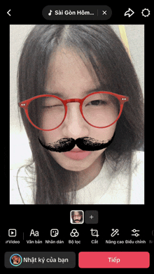 a girl wearing glasses and a fake mustache is being edited