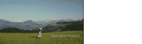a person standing in a field with the words dan leenthemont written on the grass