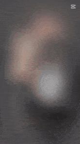 a blurred image of a woman 's face with the word capcut on the bottom