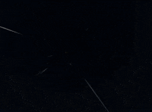 a full moon is visible in the dark sky behind a statue