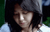 a close up of a woman 's face looking down with her eyes closed