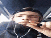 a man wearing headphones and a jacket that says ' aoaol ' on it