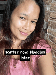 a woman in a pink shirt with the words scatter now noodles later on the bottom