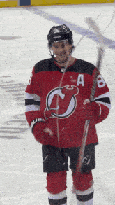 a hockey player wearing a jersey with the letter a on the front