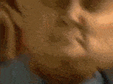 a man in a suit and tie looks at the camera