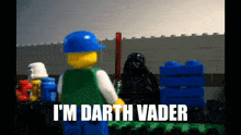 a lego character says i 'm darth vader while holding a lightsaber