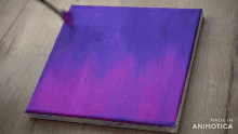 a person is painting on a purple canvas with the words made in animotica visible
