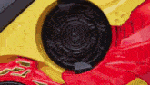 a close up of a red and yellow toy car with a speaker in the middle .