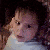 a close up of a baby 's face with a purple background