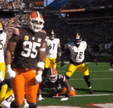 a football player wearing a number 85 jersey stands on the field