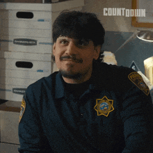 a man in a police uniform with a badge that says sheriff