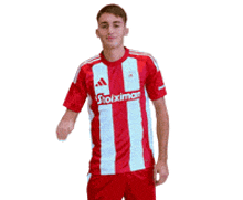 a man wearing a red and white striped shirt with the word stoiximan on the front