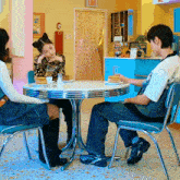 people sitting at a table with pancakes and a sign that says exit on it