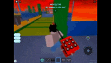 a person is playing a video game on a cell phone while holding a red box .