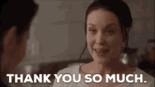 a woman is smiling while talking to a man and saying `` thank you so much . ''