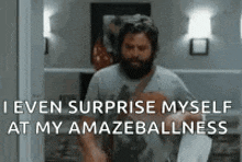 a man with a beard is holding a piece of paper and saying `` i even surprise myself at my amazement . ''